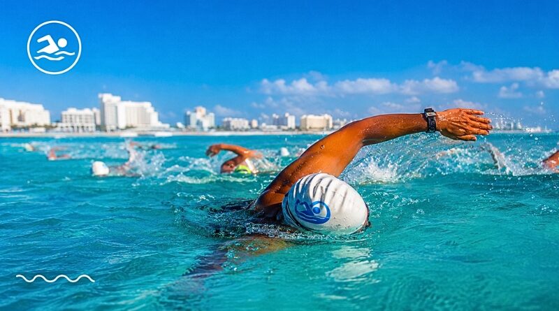 Miles de nadadores nacionales e internacionales participan en una de las competencias acuáticas más importantes de México, celebrada en las aguas turquesa del Caribe.